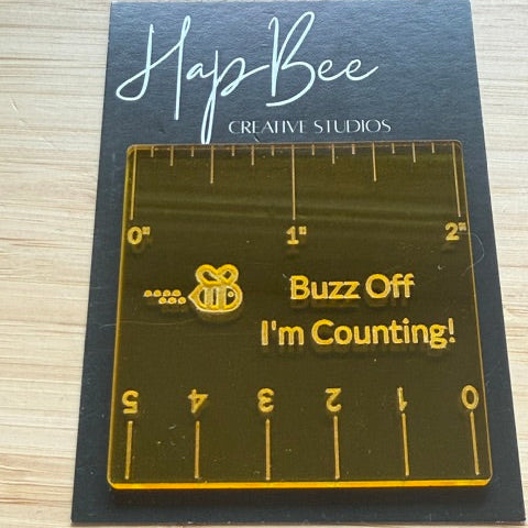 Transparent ruler with text on a blue card with 'Happy Bee Creative Studios' branding.